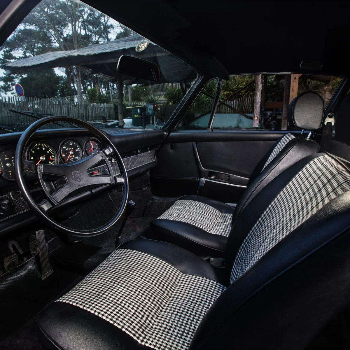 Pepita cushion shown in a classic car, lifestyle reference shot