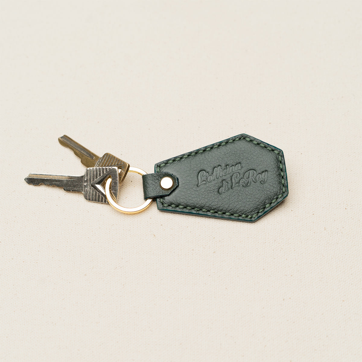Coffin Key Fob in green leather attached to a key