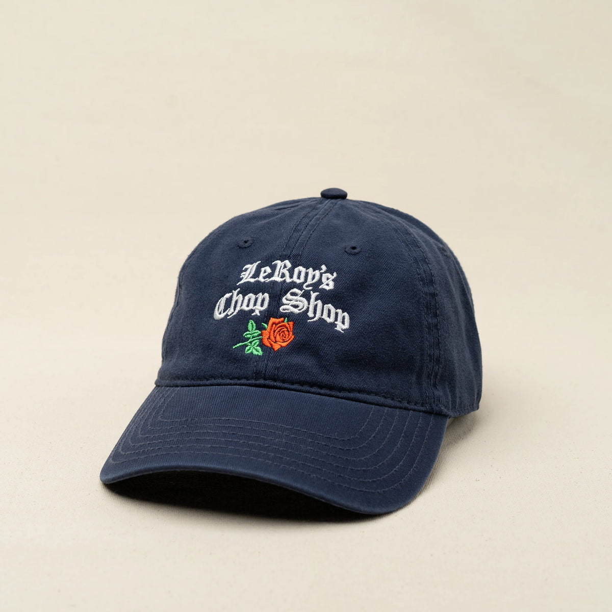 LeRoy's Chop Shop dad cap in navy with tricolor embroidered cursive logo and rose, L'officina di LeRoy