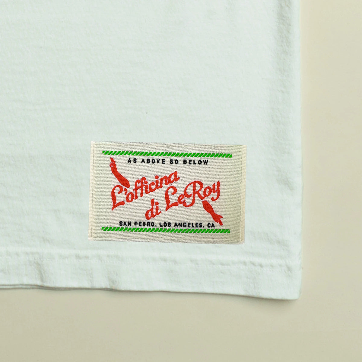 Close-up of woven ecru label on white wide crop tee