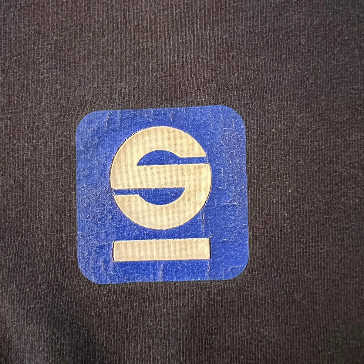 Vintage Sparco tee three-quarter view on a hanger