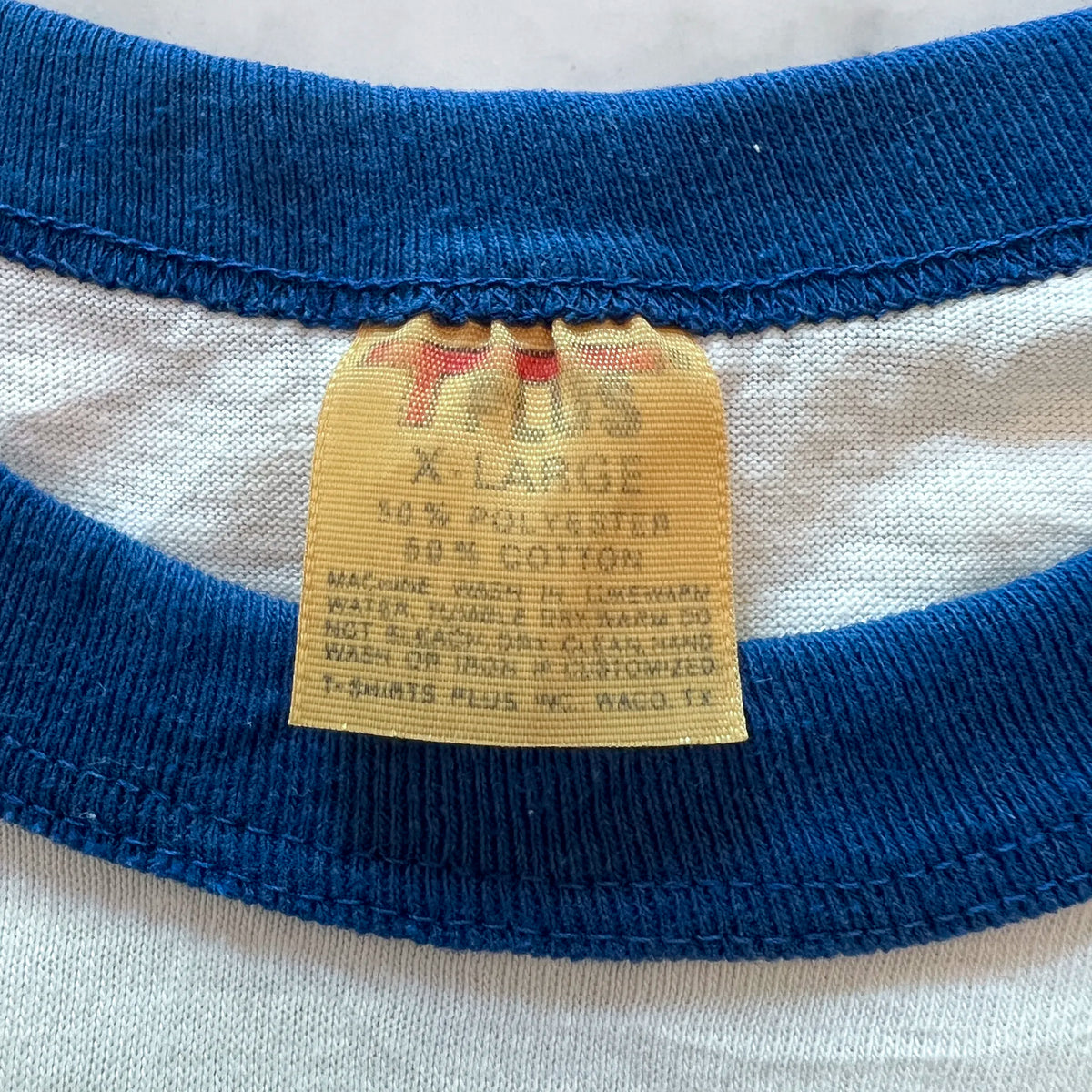 Vintage Suzuki raglan tee three-quarter view on a hanger