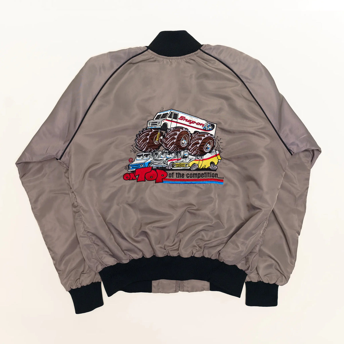 Vintage Snap-on bomber jacket in gray with On Top of the Competition monster truck graphic on back, XL