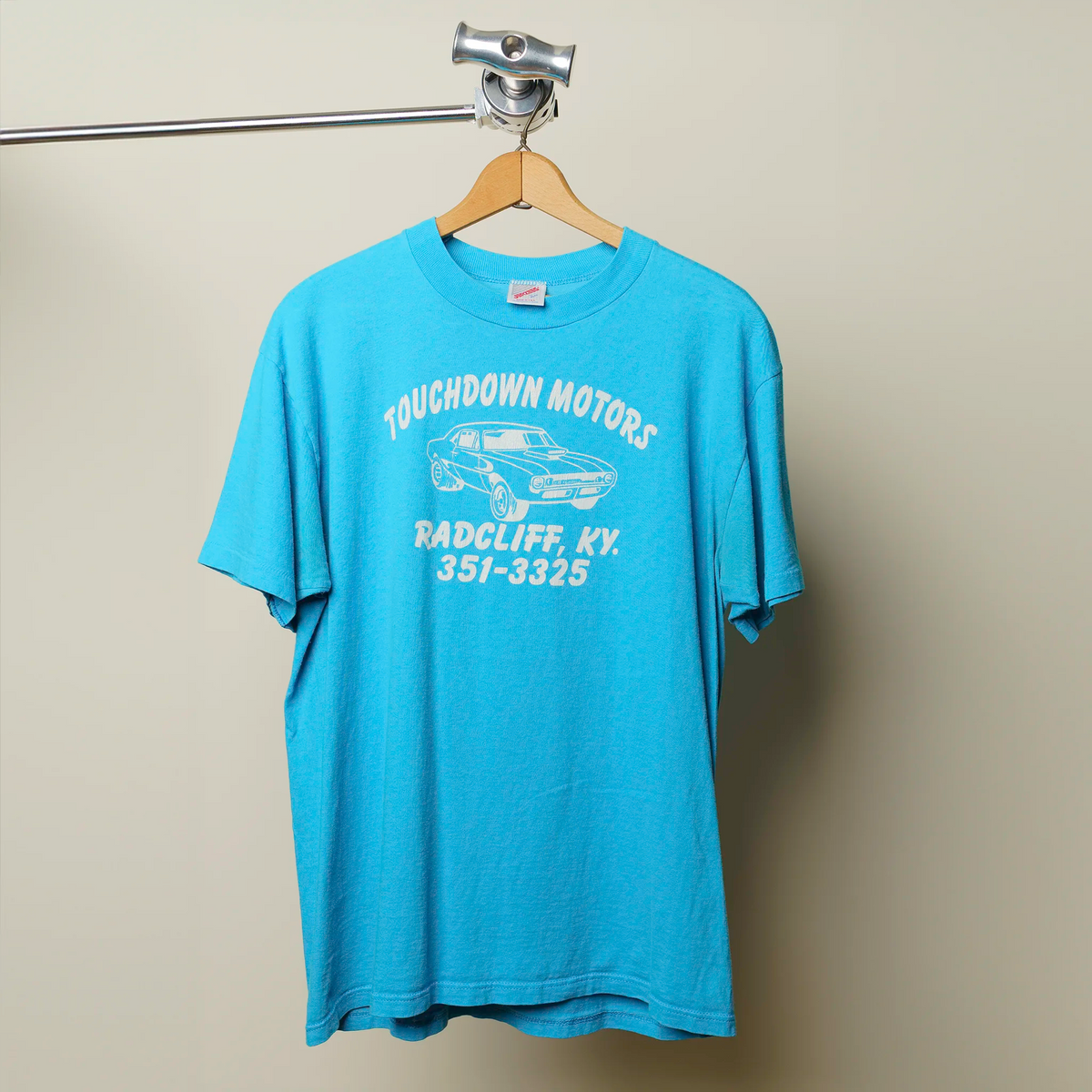 Vintage Touchdown Motors tee in bright blue with white car graphic and Radcliff KY text, large