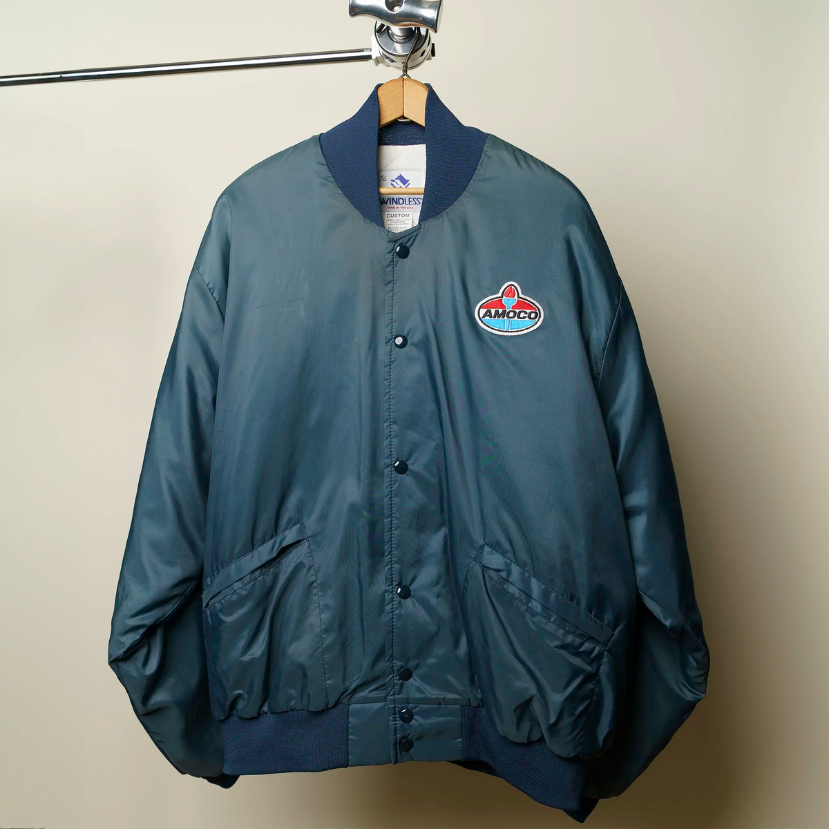 Vintage 1990s Amoco blue satin bomber jacket with Windless tag and Amoco chest patch, XL