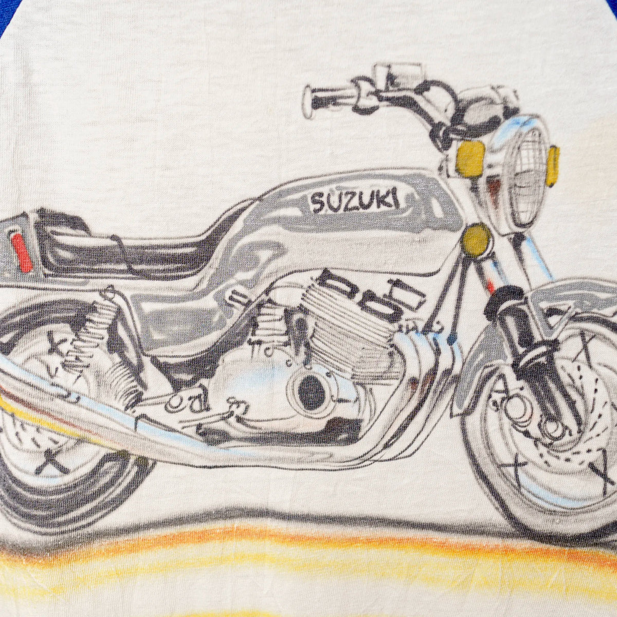Vintage Suzuki raglan tee front graphic close-up showing motorcycle illustration
