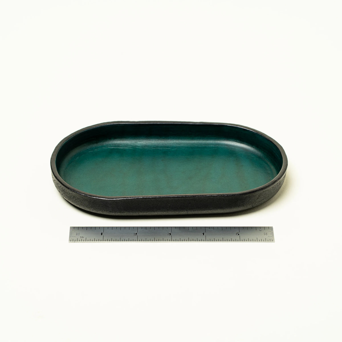Vessel leather valet tray flat lay on a beige background