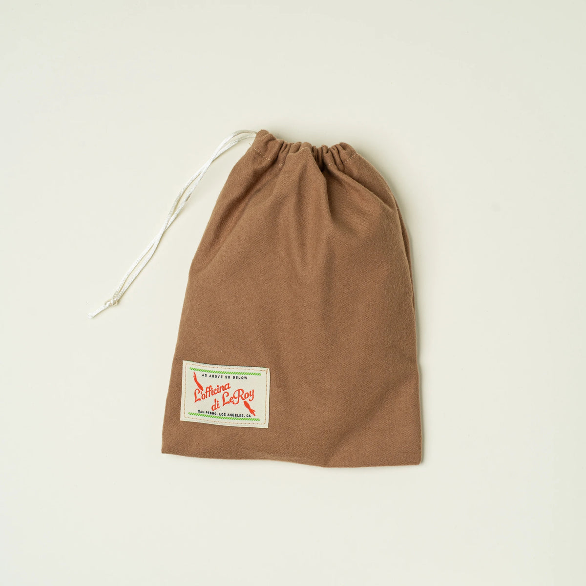 Vessel leather valet tray on a beige background, angled view