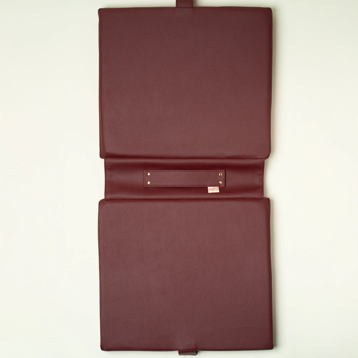Studio Check tailgate cushion on a wooden surface showing thickness