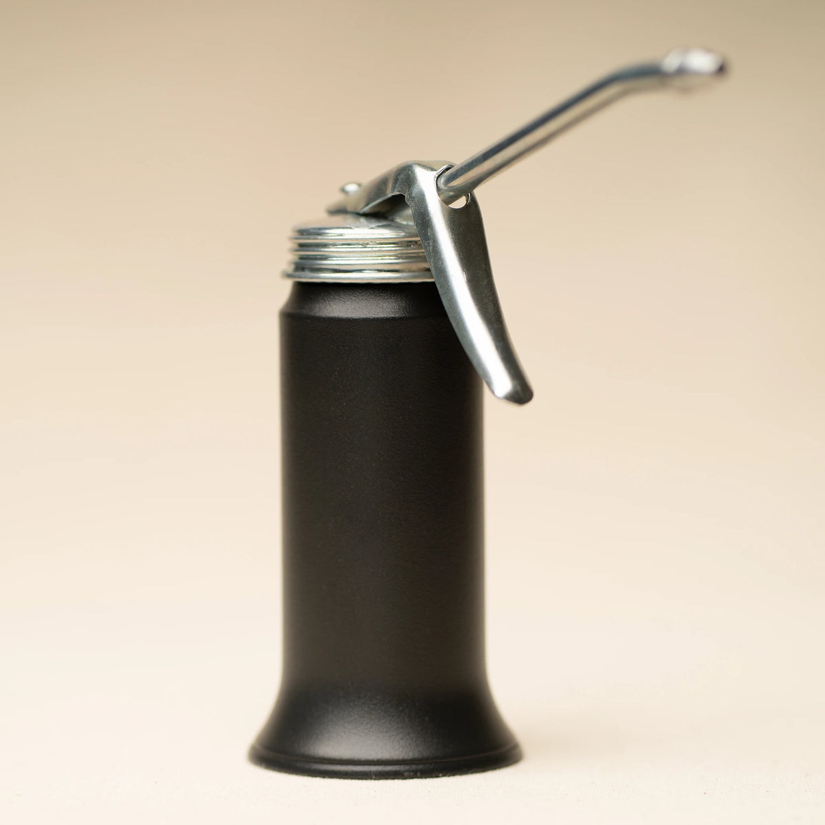 L'officina x Goldenrod mini oiler angled view on a beige background