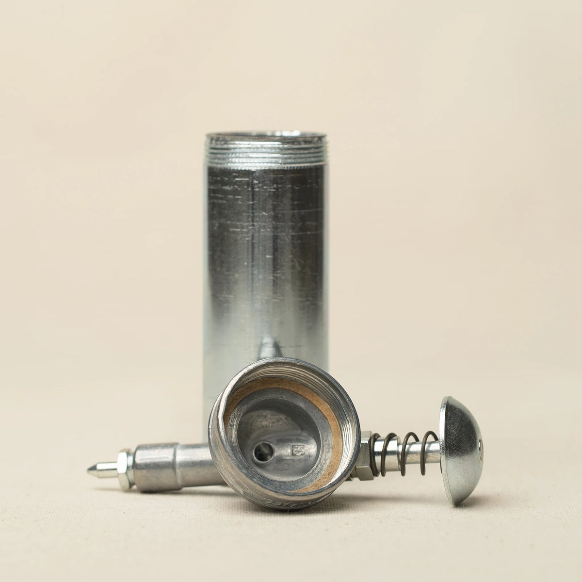 L'officina x Dualco mini grease gun disassembled showing components