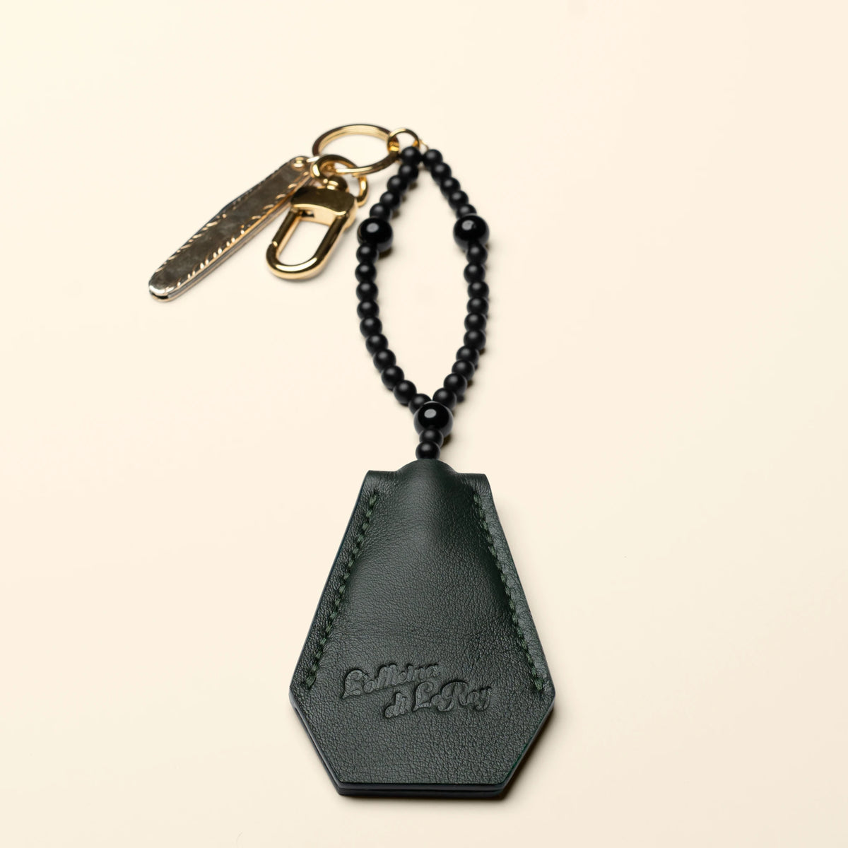 Key Coffin leather key fob reverse side on a beige background