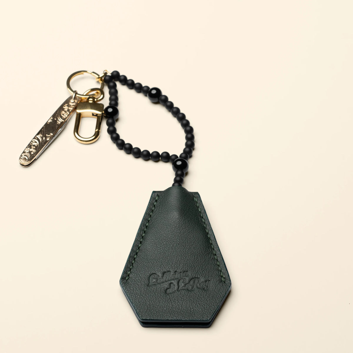 Key Coffin key fob on a beige background showing full profile