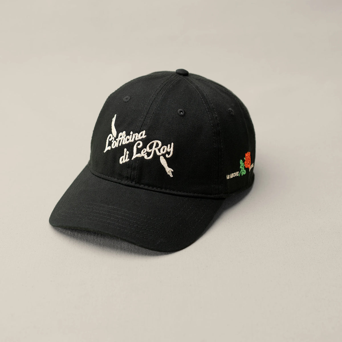 As Above So Below dad cap in black with white embroidered text and rose detail, L'officina di LeRoy