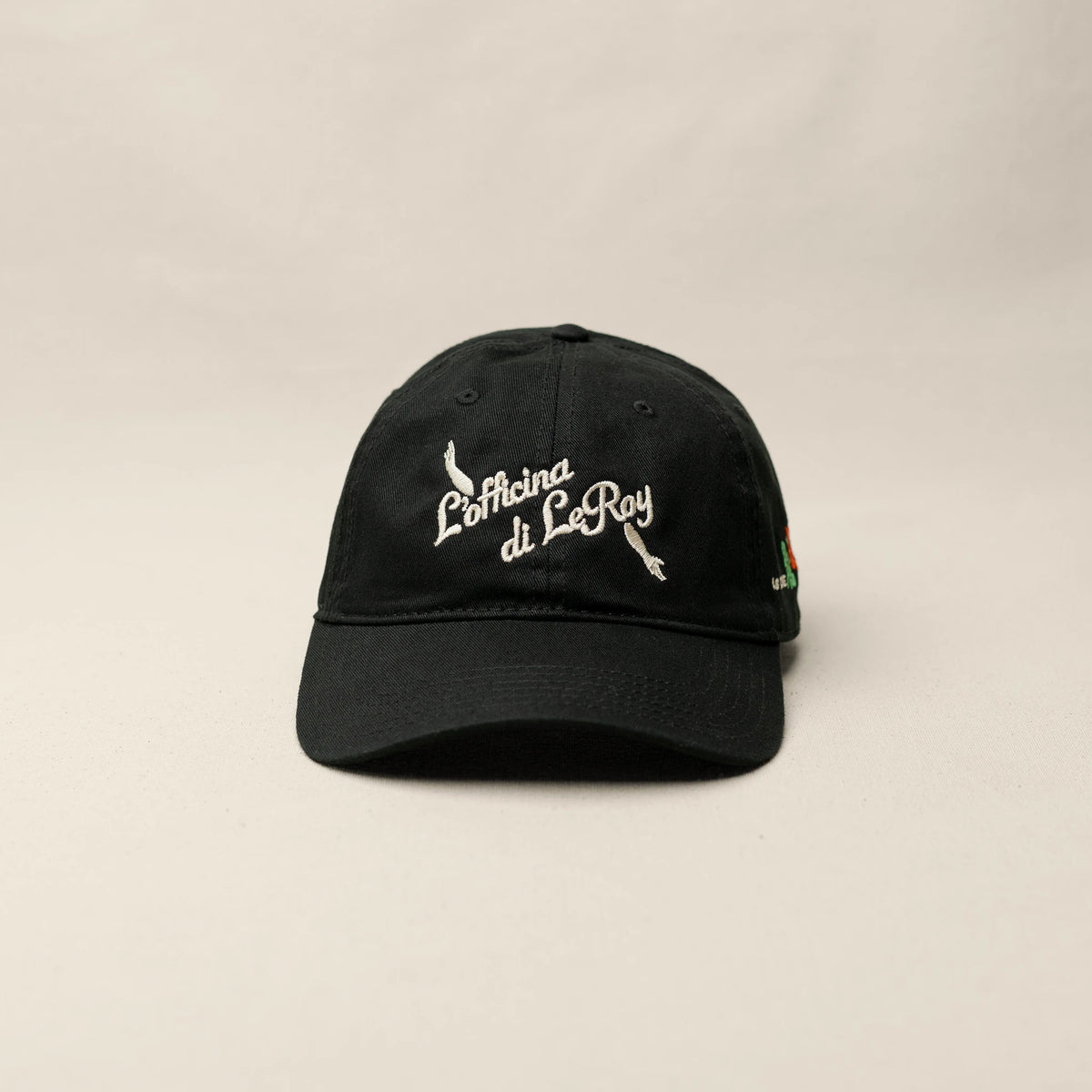 Side view of As Above So Below black cap with white embroidered text