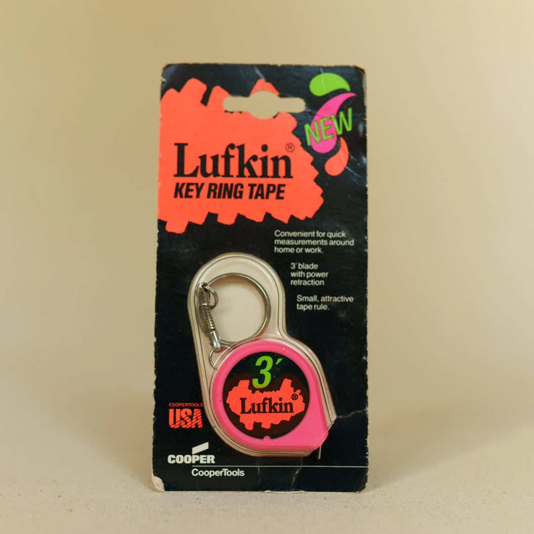 Vintage dead-stock Lufkin key ring tape measure in pink with silver ring, original packaging