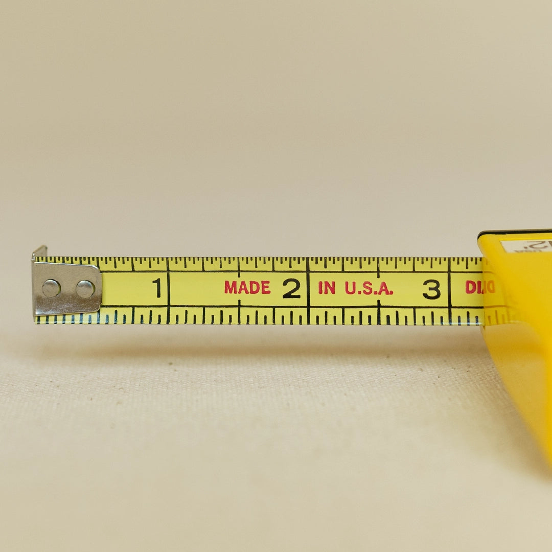 Vintage Roe tape measure extended showing tape blade and markings