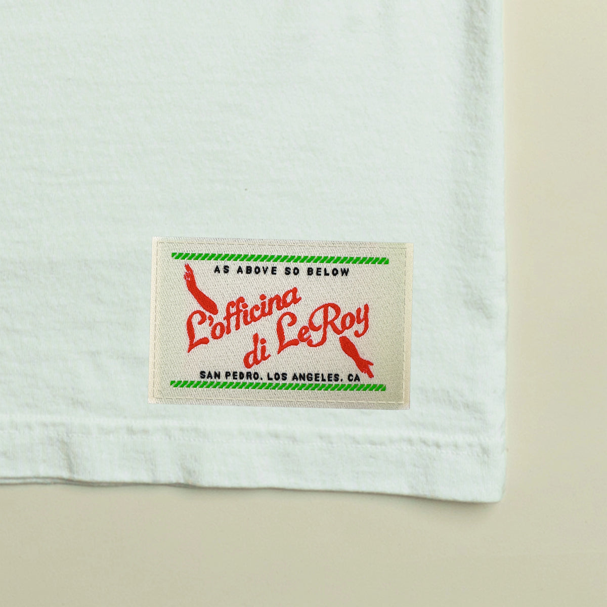 Close-up of woven ecru label detail on white heavyweight tee