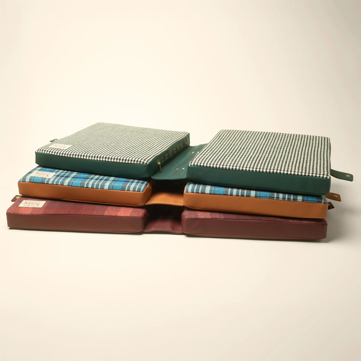 Tartan, Pepita, and Studio Check cushions in a flat lay comparison